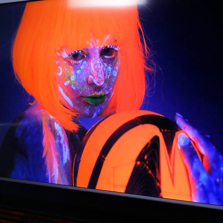 An image in neon colors on a Roku Plus Series TV.