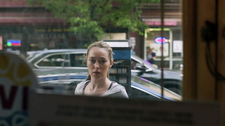 Alycia Debnam-Carey looking through a window in a scene from Saint X.