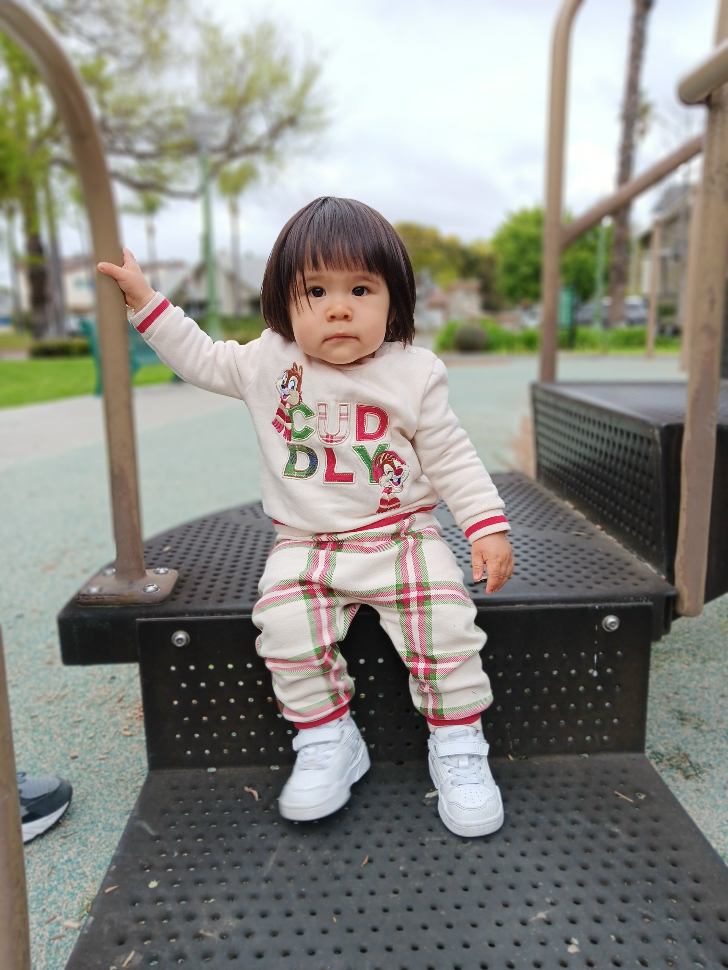 Toddler sitting on playground steps taken with Samsung Galaxy A14 5G portrait mode