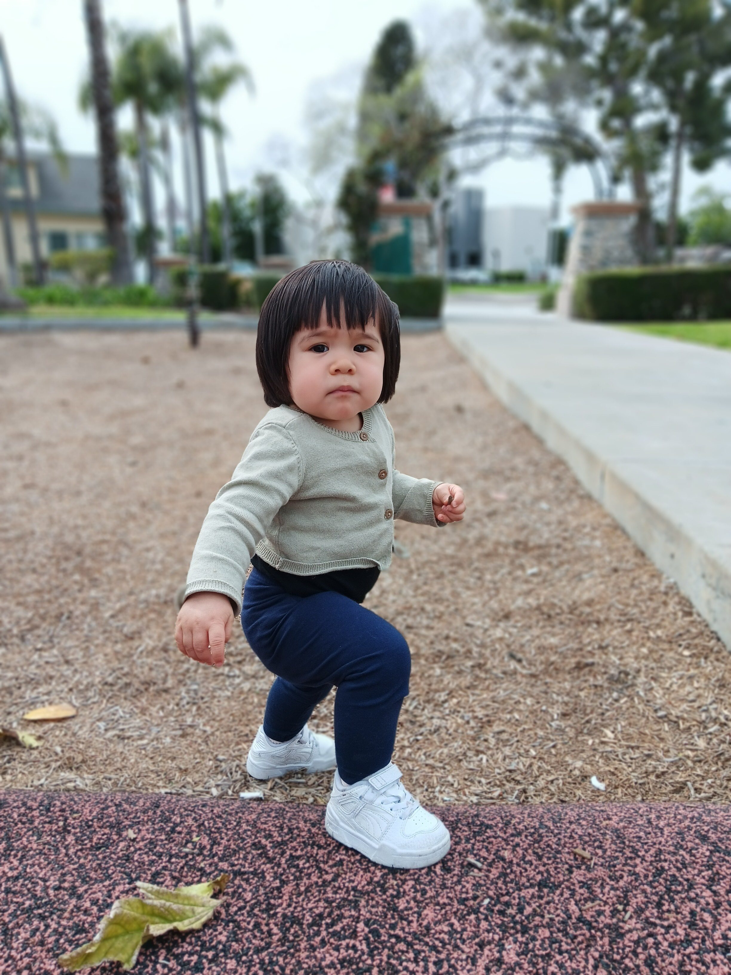 Toddler taking a step on a playground in portrait mode with Samsung Galaxy A14 5G