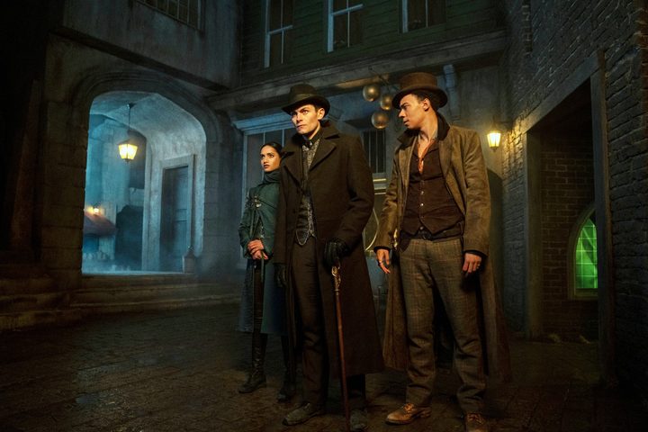 Three young people stand on a street in Shadow and Bone.