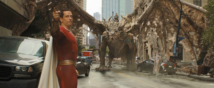 Shazam points as a dragon stands in the background in Shazam! Fury of the Gods.