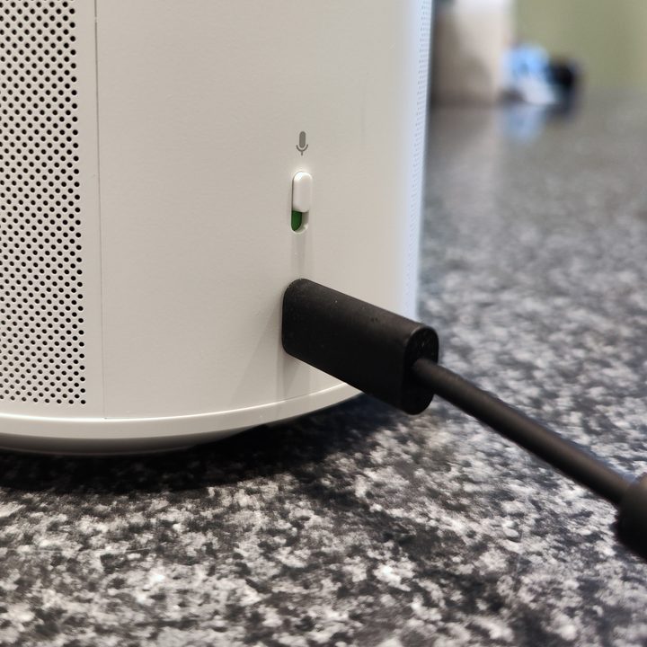 Sonos Era 100 back panel showing microphone switch and USB-C port with analog line-in adapter.