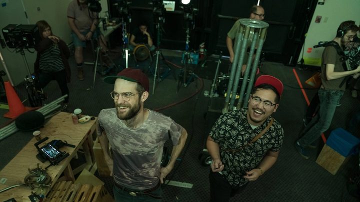 The Daniels smiling behind the scenes on the set of the movie Everything Everywhere All at Once.