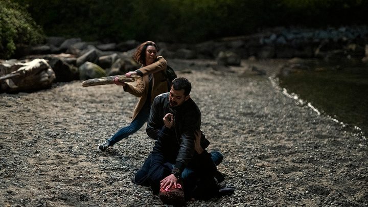 Rose about to hit Dale in the head as he holds Peter on the ground in a scene from The Night Agent.