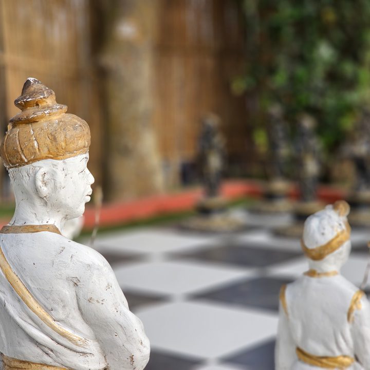Statues of assamese warriors as life-size chess pieces in white and black costumes captured with the Samsung Galaxy S23 Ultra’s 3x telephoto portrait mode camera.