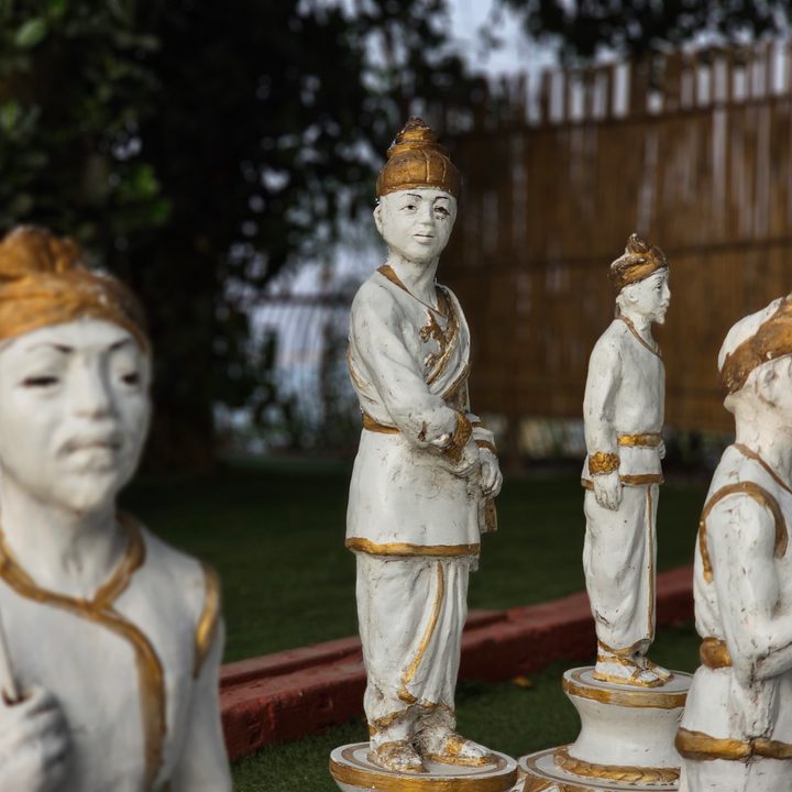 Statues of Assamese warriors with historical costumes used as life-size chess pieces in a sculpture captured with the Samsung Galaxy S23 Ultra’s 3x telephoto portrait mode camera.