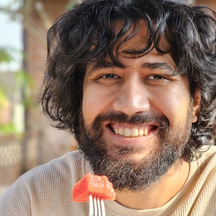 Smiling man eating watermelon captured with the Samsung Galaxy S23 Ultra’s 3x telephoto portrait mode camera.