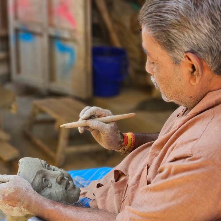 Sculptor intricately carves a face with a sharp object captured with the Samsung Galaxy S23 Ultra’s 3x telephoto portrait mode camera.