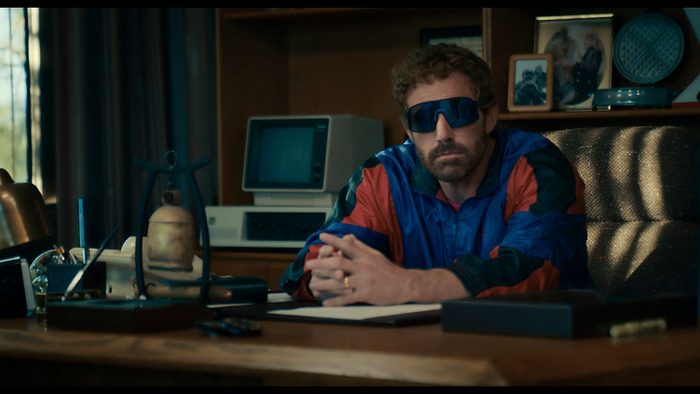 Ben Affleck sits a table with sunglasses on in Air.