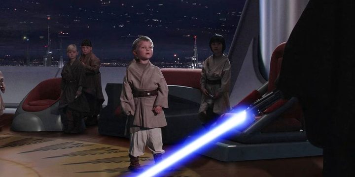 A child looks at a lightsaber in Revenge of the Sith.