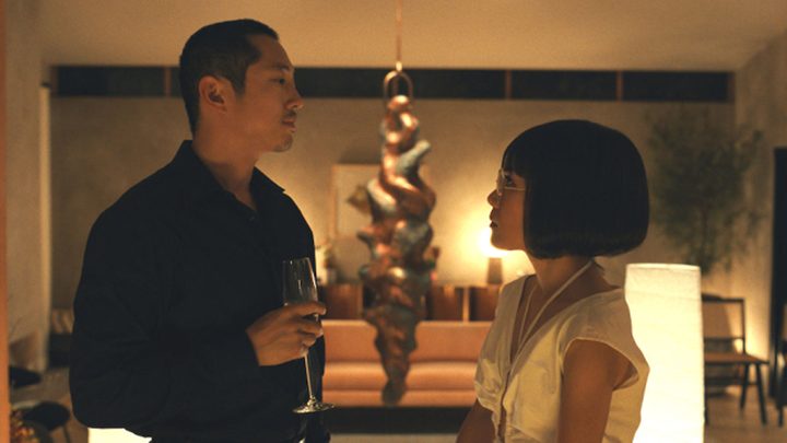 Steven Yeun and Ali Wong as Danny and Amy looking at each other confrontationally in Beef.