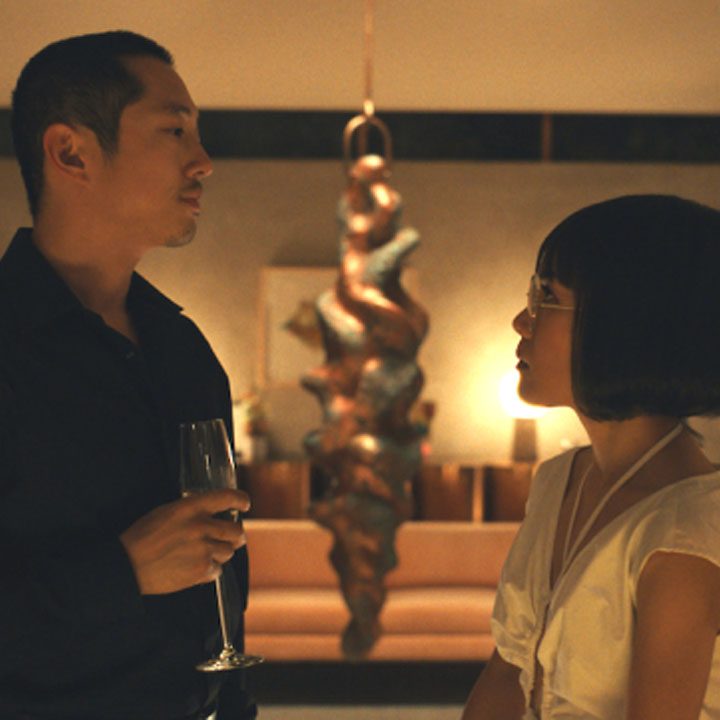 Steven Yeun and Ali Wong as Danny and Amy looking at each other confrontationally in Beef.