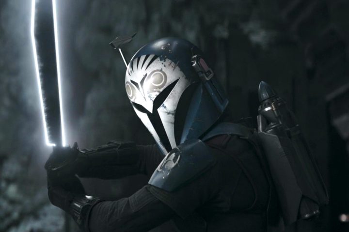 Bo-Katan holds up the Darksaber in The Mandalorian season 3 finale.