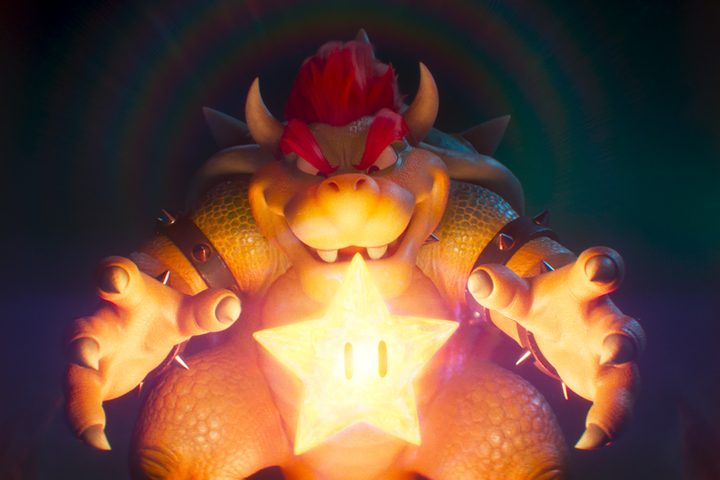 Bowser stands in front of a super star in The Super Mario Bros. Movie.