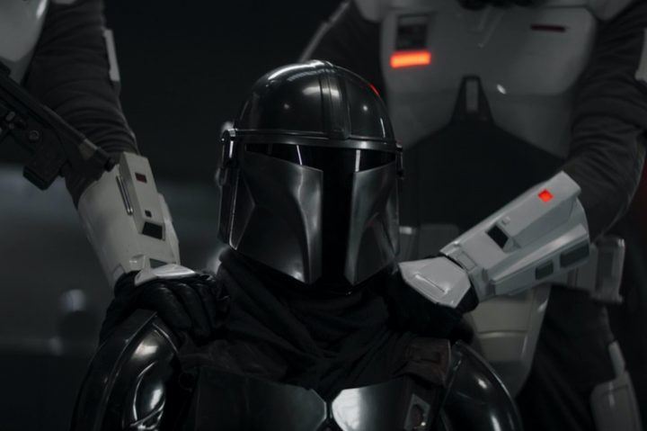 Imperial troopers hold down Din Djarin in The Mandalorian season 3 episode 7.