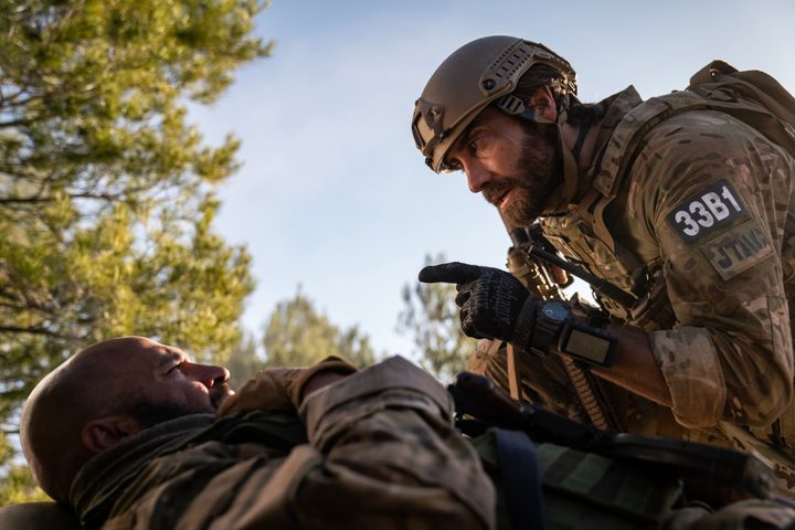 Jake Gyllenhaal kneels over Dar Salim in Guy Ritchie's The Covenant.