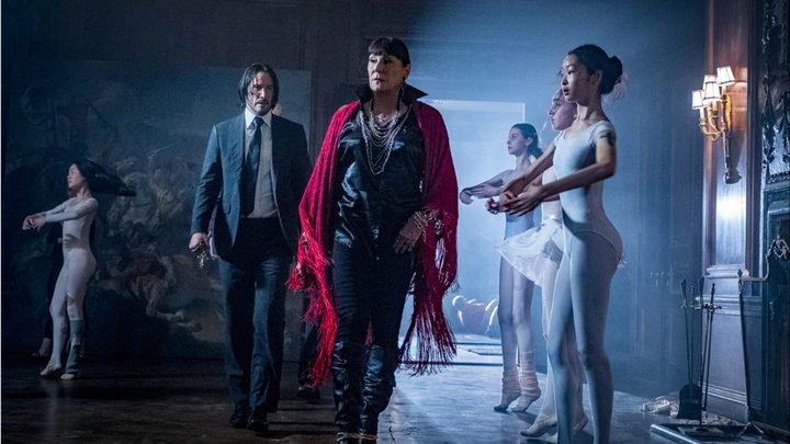 John Wick walks and stands behind the Director in John Wick 3.