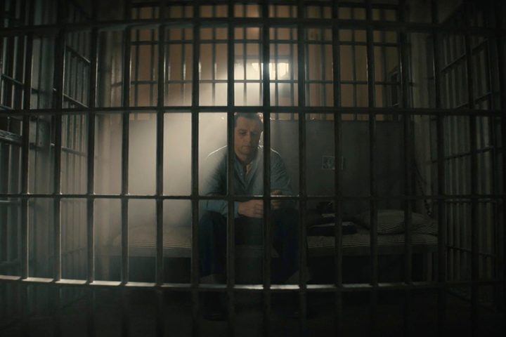 Matthew Rhys sits in a prison cell in the Perry Mason season 2 finale.