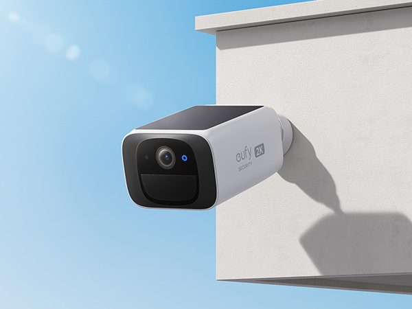 Eufy S220 SoloCam solar-powered security camera mounted to side of house.