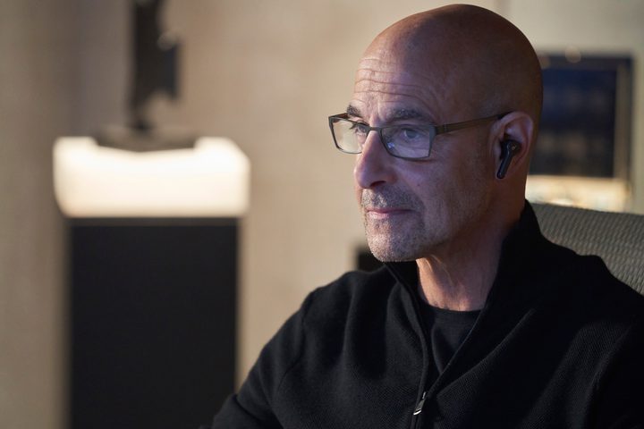 Stanley Tucci wears glasses and an earpiece in Citadel.