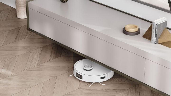 The Deebot T10 Omni maneuvering under a piece of furniture.