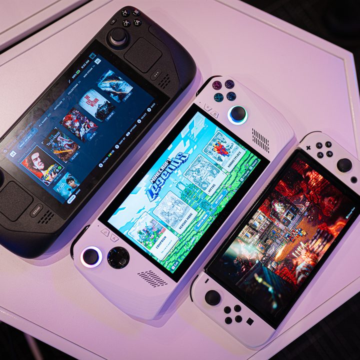 A Steam Deck, Asus ROG Ally, and Nintendo Switch OLED sit on a table.