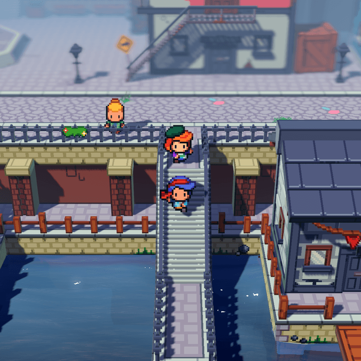 Two characters walk through a seaside town in Cassette Beasts.