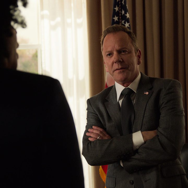 Kiefer Sutherland as Thomas Kirkman standing in his office with his arms folded in a scene from Designated Survivor.