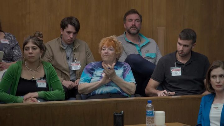 Members of the jury sitting in a scene from Jury Duty.