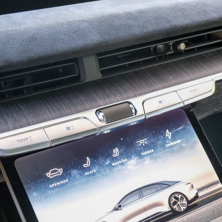 A close up of manual and touch controls on a Lucid Air infotainment panel.
