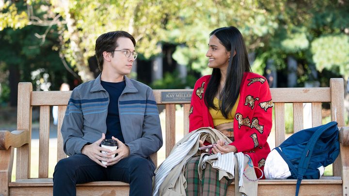 Mekki Leeper sitting with a female character on a park bench in a scene from The Sex Life of College Girls.