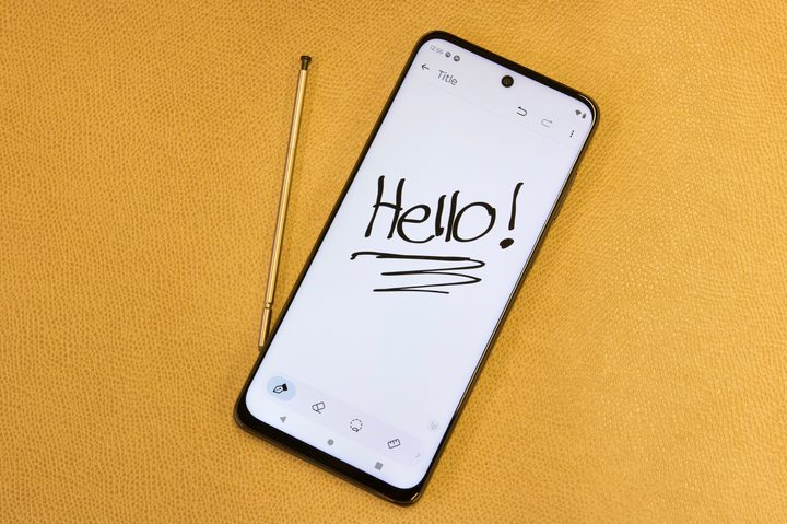 The Moto G Stylus 5G 2023 with its display on, and its stylus right next to it.
