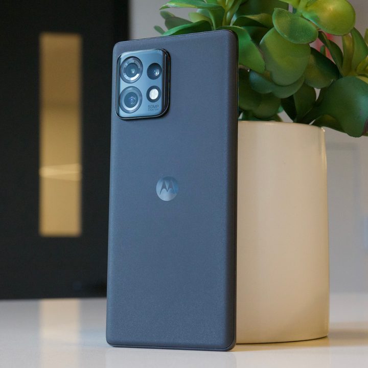 The Motorola Edge Plus 2023 standing upright against a potted plant.
