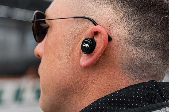 Man wearing PSB M4U TWM wireless earbuds.