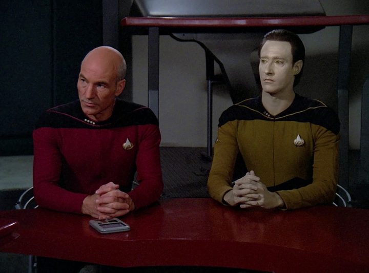 Picard and Data sit at a table in Star Trek: The Next Generation.