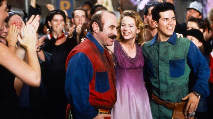 Two men and a woman celebrate in Super Mario Bros.