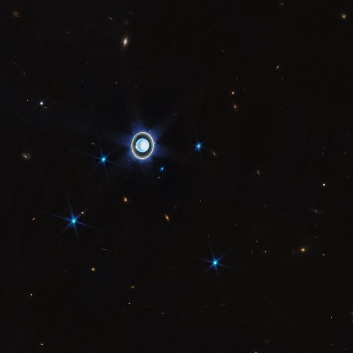 This wider view of the Uranian system with Webb’s NIRCam instrument features the planet Uranus as well as six of its 27 known moons (most of which are too small and faint to be seen in this short exposure). A handful of background objects, including many galaxies, are also seen.