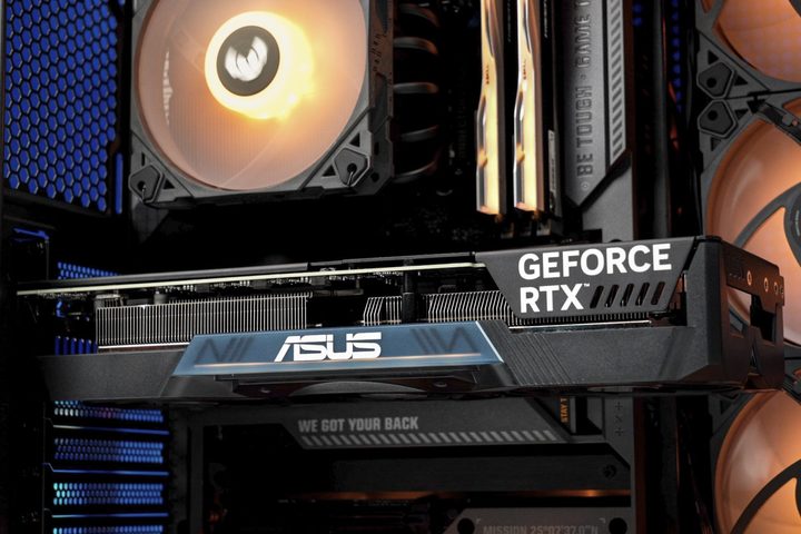 The inside of a PC build, showing an Asus graphics card with hidden cables and power connectors.