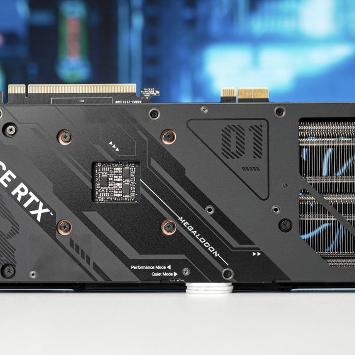 An Asus GeForce RTX 4070 Megalodon graphics card seen from the rear on a table.