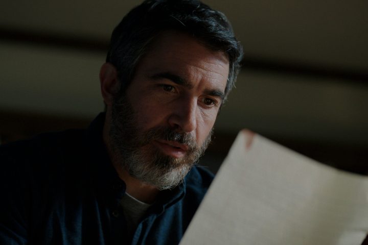 Chris Messina looks at a piece of paper in The Boogeyman.