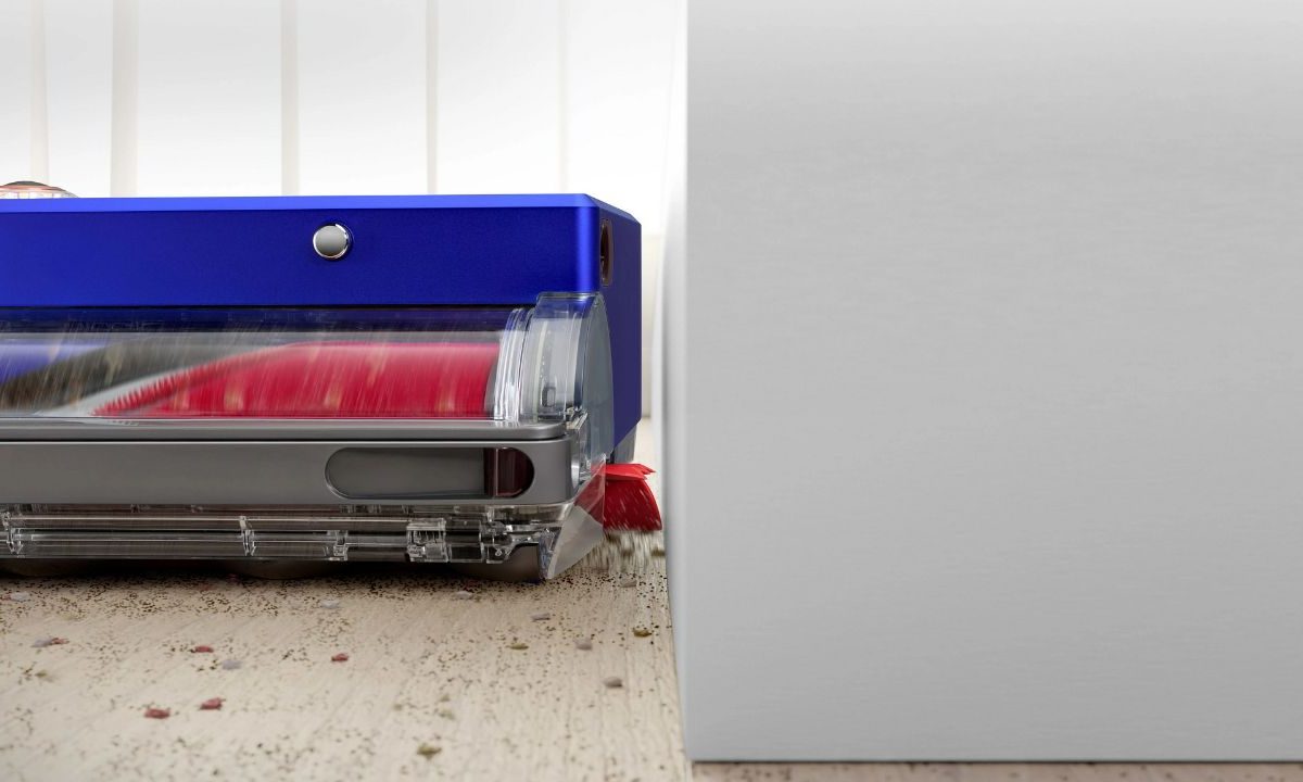 The Dyson 360 Vis Nav cleaning near a wall.