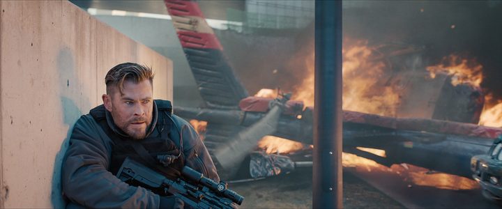 A man holds a gun in Extraction 2.