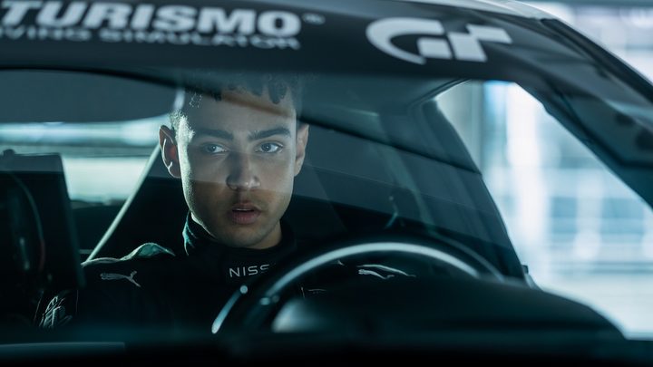 A man sits behind the steering wheel in Gran Turismo.
