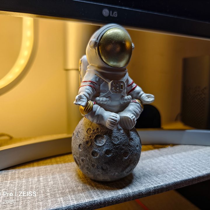 Astronaut figurine in low light captured by Vivo X90 Pro.
