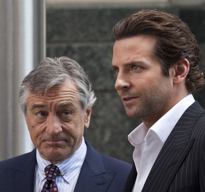 Robert De Niro and Bradley Cooper stand next to each other and stare in Limitless.
