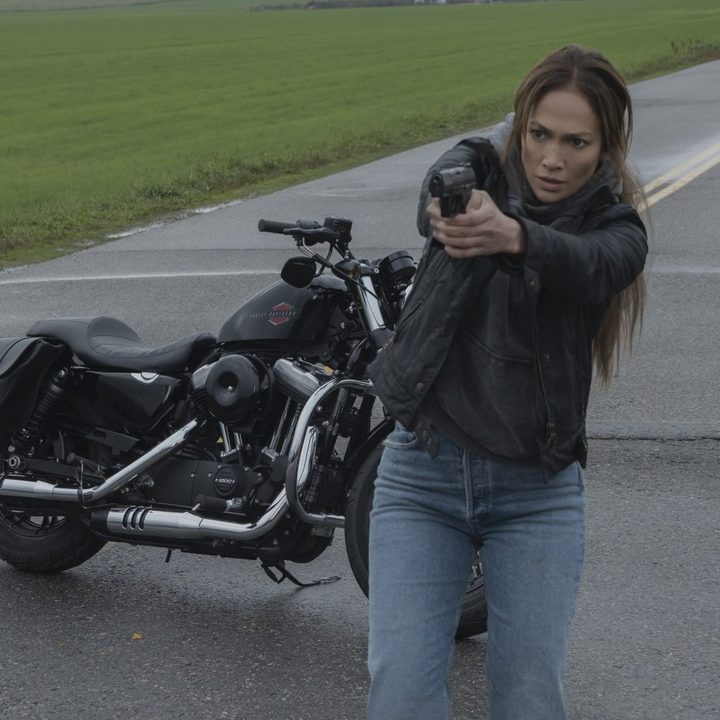 Jennifer Lopez points a gun while in front of her motorcycle in The Mother.