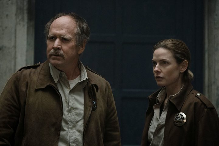 Marnes and Juliette stand near a door together in Silo.