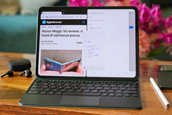 OnePlus Pad keyboard folio and stylus placed on a wooden table alongside black OnePlus Buds Pro 2 and gray OnePlus 11.