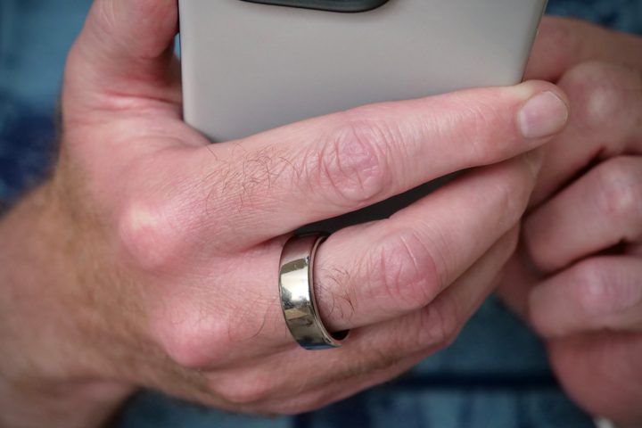 The Oura Ring on a person's finger.